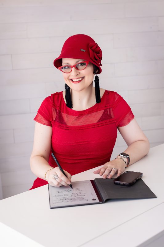 Nicole sitting at desk taking detailed notes